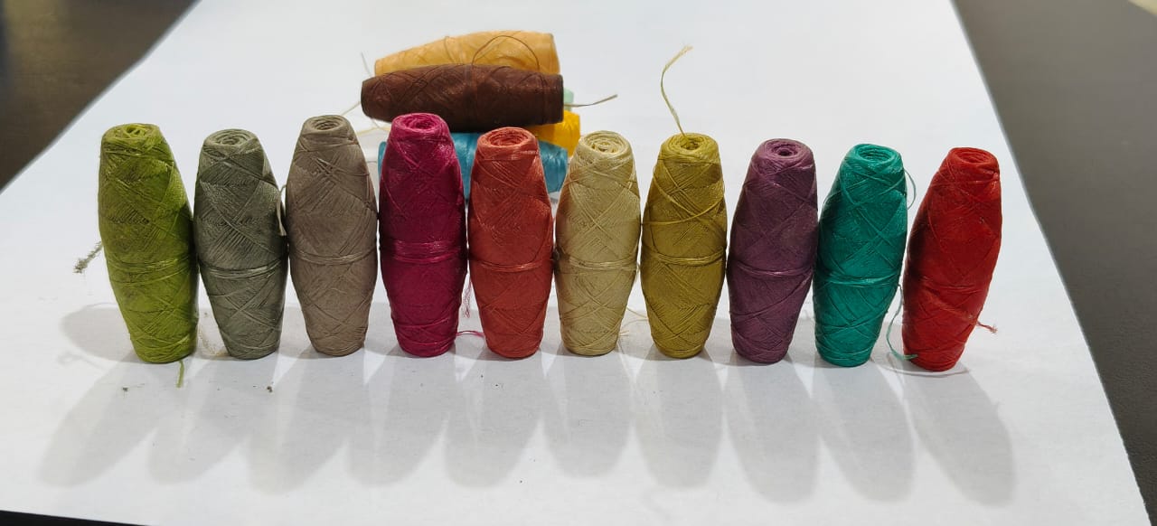 Cocoon bobbins manufactured by A.A Brothers in Faisalabad, shown across the colour range
